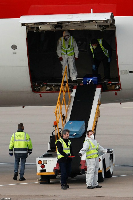 25848496-8099369-Workers_unload_the_luggage_of_the_British_nationals_from_the_cru-a-2_1583970286004.jpg