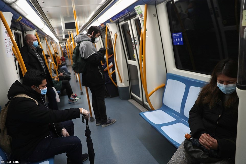 27121816-8215425-Passengers_keep_their_distance_riding_the_metro_in_Madrid_as_non-a-63_1586826282570.jpg