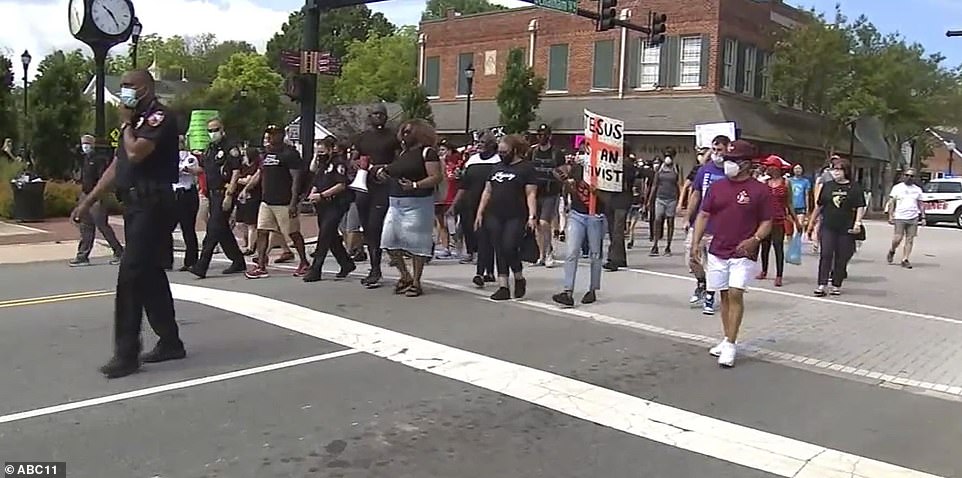 29337280-8397065-The_prayer_walk_pictured_hitting_the_streets_of_Cary_with_protes-a-4_1591618964977 (1).jpg