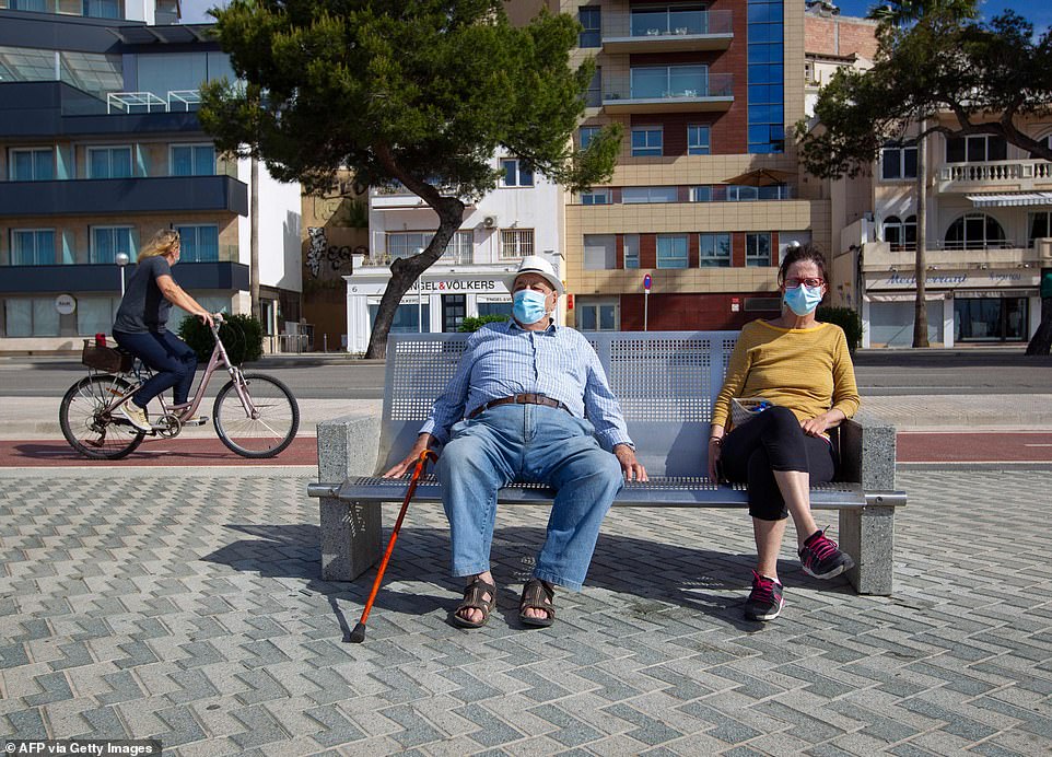 27921328-8277783-An_elderly_man_sits_beside_a_woman_on_a_bench_in_Palma_de_Mallor-a-67_1588456599888.jpg